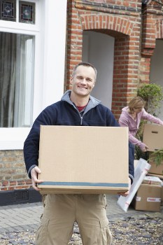 Man and van loading furniture in Bounds Green residential street