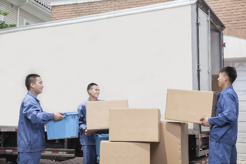 Removal van and moving boxes in a residential North London street