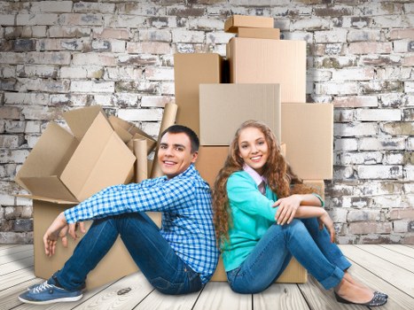Packed moving boxes and wrapped household items ready for transport
