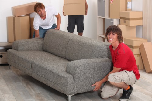 Careful loading of household items into a removals vehicle in Bounds Green