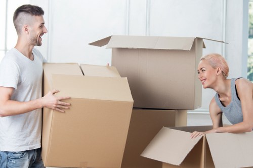 Professional movers handling furniture near a flat entrance
